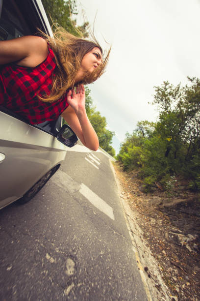 istock Girl enjoying in car drive 1384209655