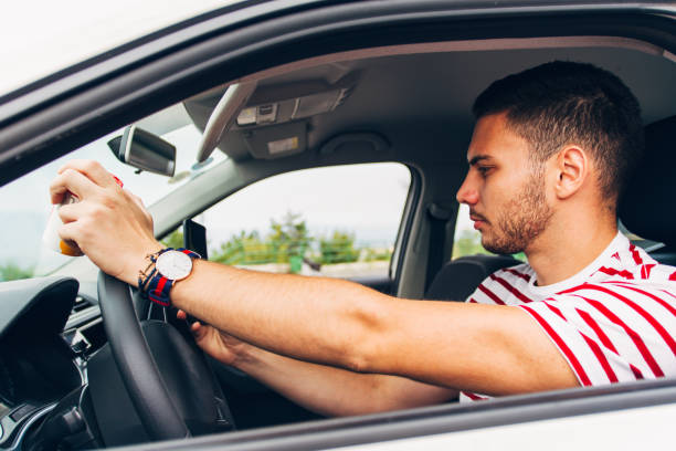 istock Reckless guy in a car looking at his phone 1384209665