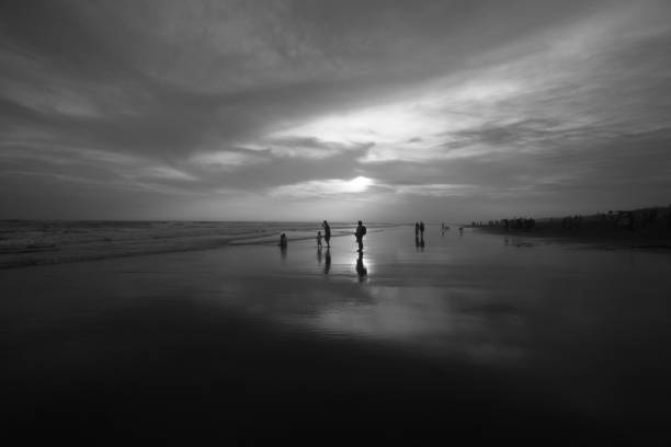 the sunset atmosphere at Parangtritis beach, Bantul, Special Region of Yogyakarta. I took this picture in monochrome to get silhoutte of people on the beach and to get deep impression of the sunset