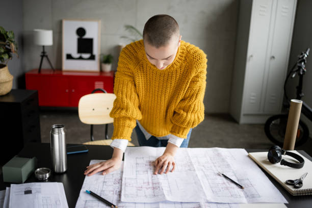 istock Professional Caucasian female architect working in her office 1384217228