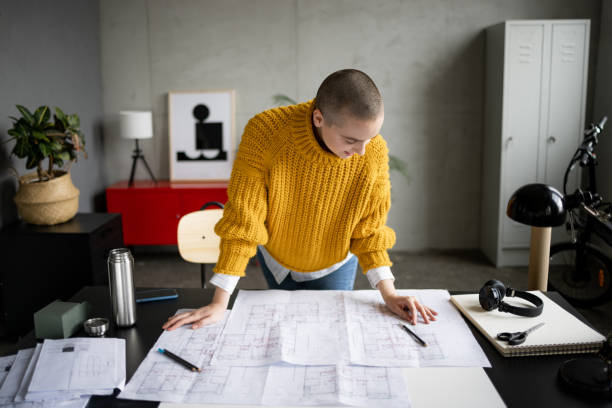 istock Professional Caucasian female architect working in her office 1384217247