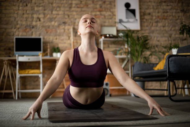 istock Young Caucasian woman practicing yoga at home 1384217567