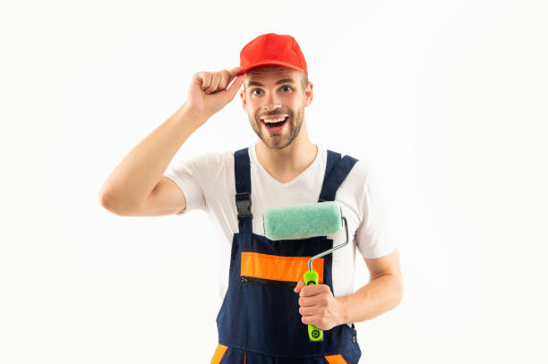 istock positive renovator making surface repair. man hold paint roller. guy in cap isolated on white 1384217753