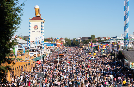 Munich, Germany - September 21, 2019: Crowd of people on the Theresienwiese, the Oktoberfest in Munich at opening day. The Oktoberfest is the largest fair in the world and is held annually in Munich.