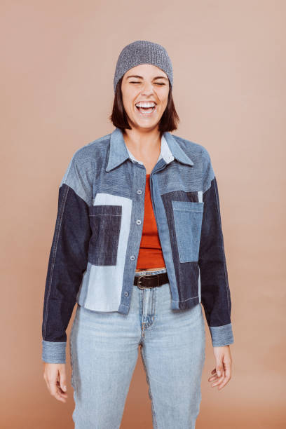 istock Young smiling female with winter clothes at studio 1384220497