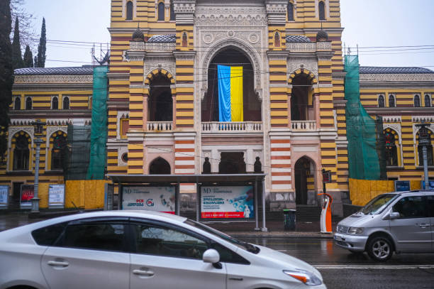 TBILISI, GEORGIA - MARCH 11, 2021. Ukrainian flag waving hang on Georgian National Opera and Ballet Theater of Tbilisi balcony in support of Ukraine. stock photo