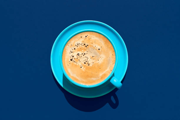 cup of coffee above view on a blue background. hot coffee in a blue mug. - coffee cup isolated cappuccino multi colored imagens e fotografias de stock