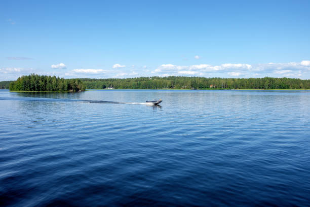 Beautiful view from the deck of the cruise ship going up the Lake Saimaa, Lappeenranta, Finland on a warm sunny day.