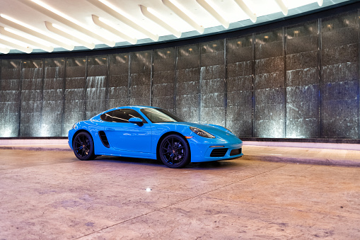 Palm Beach, Florida USA - March 22, 2021: blue Porsche 718 Cayman luxury sport car in palm beach, united states of america. side corner view. Porsche is luxury car brand