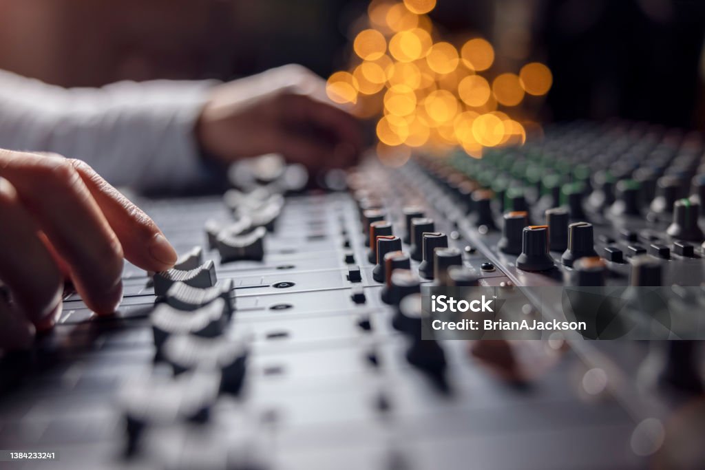 Sound recording studio mixing desk with engineer or music producer Sound recording studio mixing desk with engineer or music producer pov Sound Engineer Stock Photo