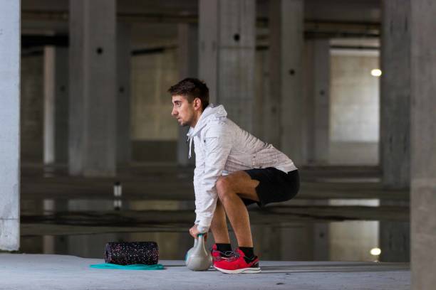 istock Caucasian Male Athlete Doing Kettlebell Exercise 1384234486