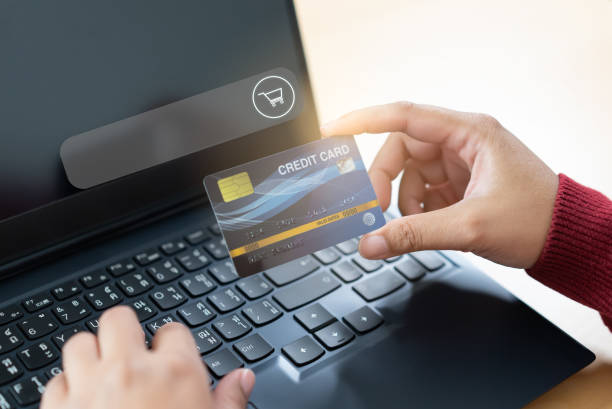 istock Online shopping browser with hand holding credit card 1384237330