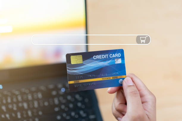 istock Online shopping browser with hand holding credit card 1384237407