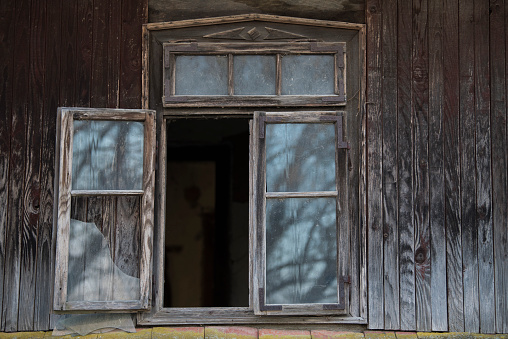 Sunja, Croatia, April 20,2021 : Rustic style aged window at rural home wall.