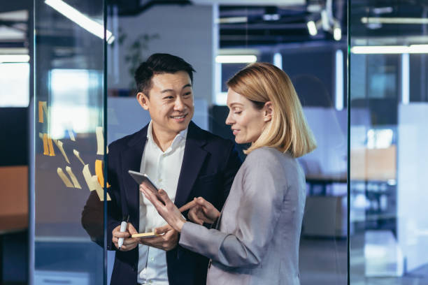 istock Team of business workers develop a business strategy, and develop a plan, an Asian man smiles at a female companion 1384238711