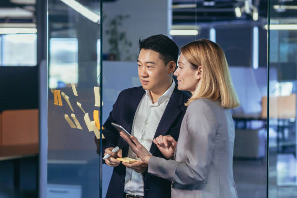 istock Team of business workers develop a business strategy, and develop a plan, an Asian man smiles at a female companion 1384238712