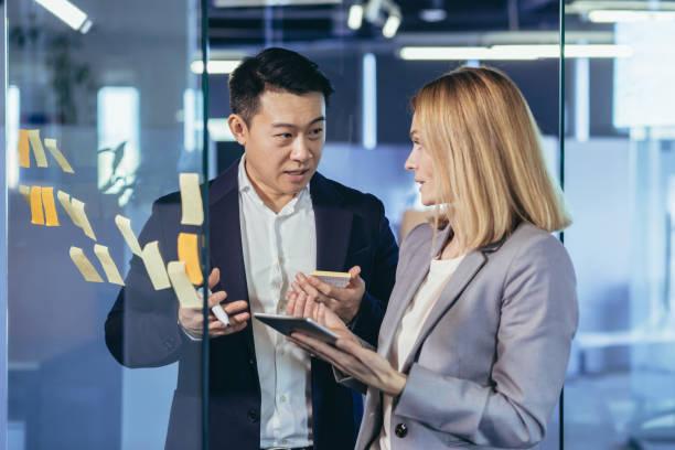 istock Team of business workers develop a business strategy, and develop a plan, an Asian man smiles at a female companion 1384238714