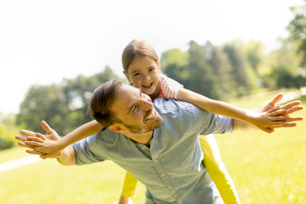 istock Father with daughter having fun at the park 1384242972
