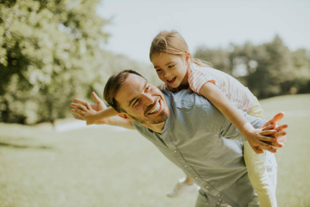 istock Father with daughter having fun at the park 1384242973