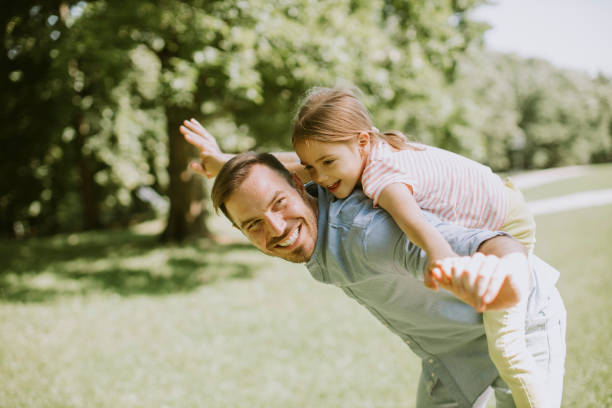 istock Father with daughter having fun at the park 1384242975
