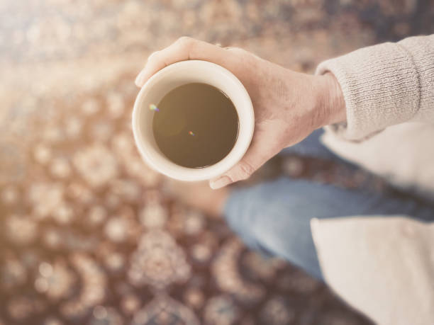 istock Woman holding coffee 1384243145