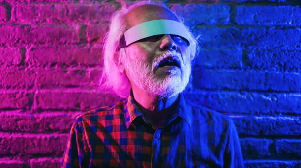 istock Asian senior man using augmented reality futuristic glasses - New technology trend concept - Focus on face 1384247985