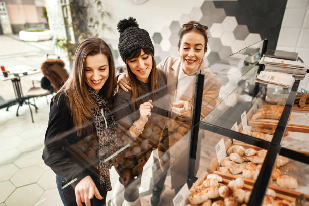 istock Female customers in bakery choosing which pastry item to eat for breakfast 1384250776