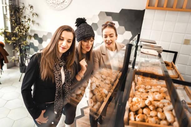istock Female customers in bakery choosing which pastry item to eat for breakfast 1384250801