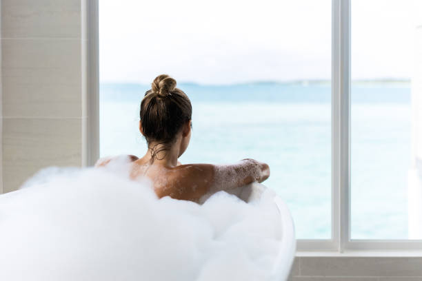 istock Back view of a woman taking a bath. 1384251508