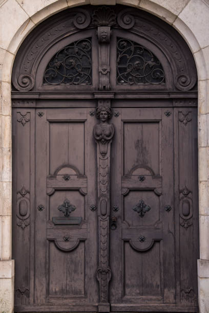 istock Old decorated wooden front door. 1384253047