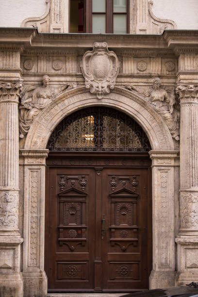 istock Old decorated wooden front door. 1384253050
