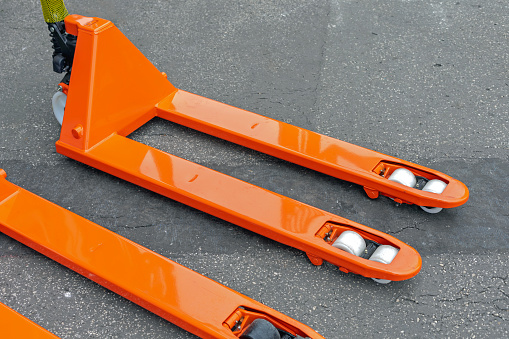 Long Orange Forks With Wheels at Pallet Jack