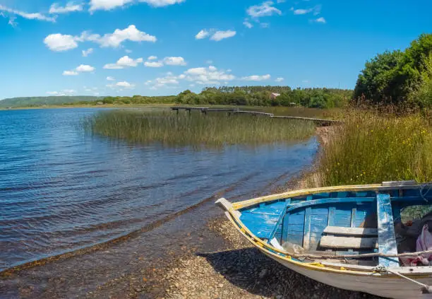 Photo of Old fishing boat on a lake in the ChiloÃ© National Park on the western coast of ChiloÃ© Island, Los Lagos Region (region of the lakes), Chile