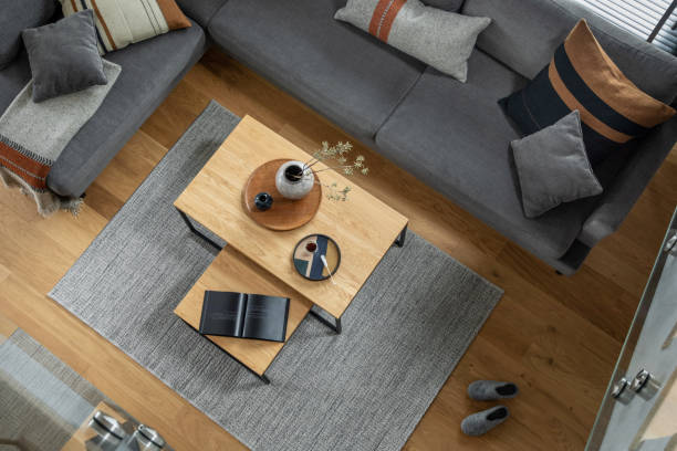 istock Stylish top view composition of living room interior with corner grey sofa, coffee table, carpet and minimalist personal accessories. Modern home decor.  Parquet floor. Template. 1384255948