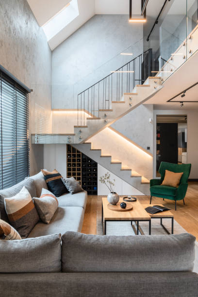 stylish composition of stairs in living room interior. grey sofa, green velvet armchair, coffee table and minimalist personal accessories. modern home decor. template. - vertical architecture imagens e fotografias de stock