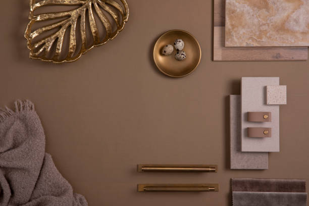 istock Creative flat lay composition with textile and paint samples, panels and tiles. Stylish interior designer moodboard. Golden and dark beige color palette. Copy space. Template. 1384259457