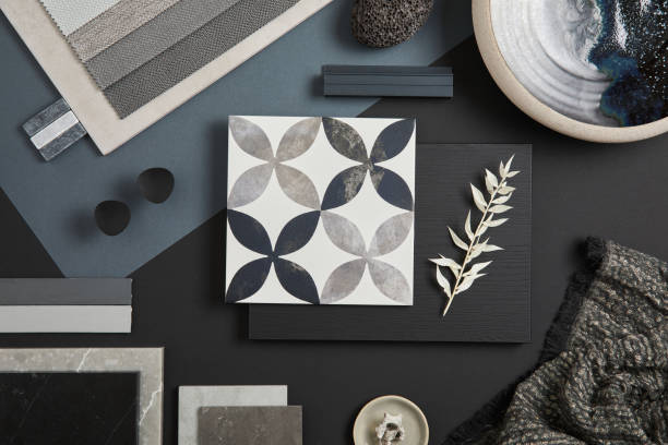 Flat lay of stylish architect moodboard composition with black, beige and grey samples of textile, paint, panels and tiles. Top view. Copy space. Template. stock photo