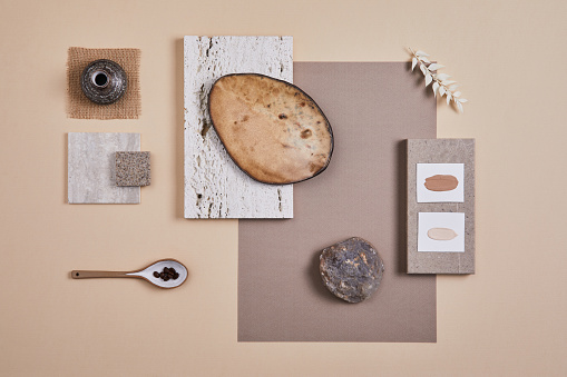 Creative flat lay composition with textile and paint samples, panels and cement tiles. Stylish interior designer moodboard. Light beige color palette. Copy space. Template.
