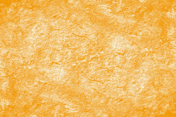 istock Seamless light orange grunge textured wall surface for background 1384259794