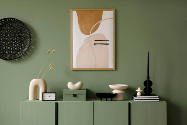 istock Modern living room interior composition with mockup frame and modern home decorations and personal accessories on the sage green wooden commode. Eucalyptus wall. Template. Copy space. 1384261995