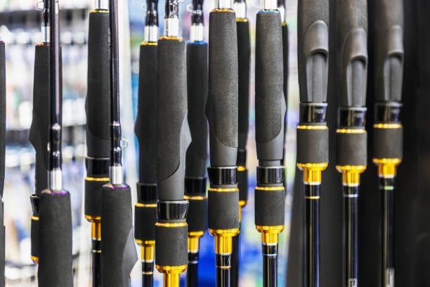 fishing rods of different construction and purpose on the counter of the store stock photo
