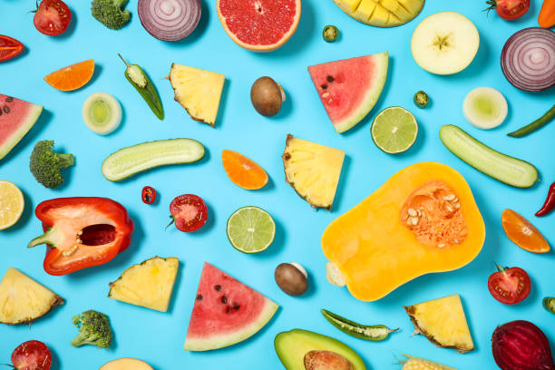 istock Flat lay composition with fresh organic fruits and vegetables on light blue background 1384264185