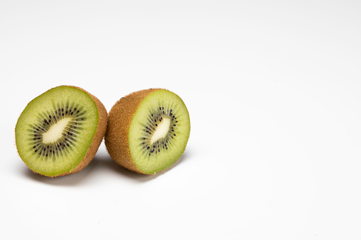 Green fruit kiwi slice on dark background.