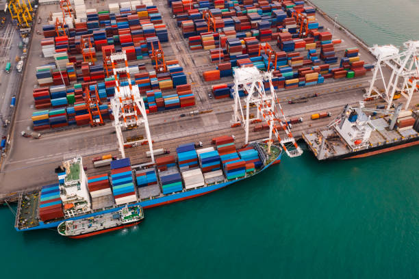 istock Containers ship and shipping ports cargo logistic freight load unloading by crane forwarding industry import export international worldwide, business services transportation of goods in ocean waters Asia Pacific and Europe photograph aerial view 1384265808