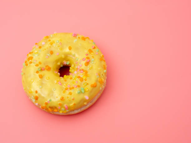 istock Fresh lemon donut on a pink background. lemon donut 1384266943