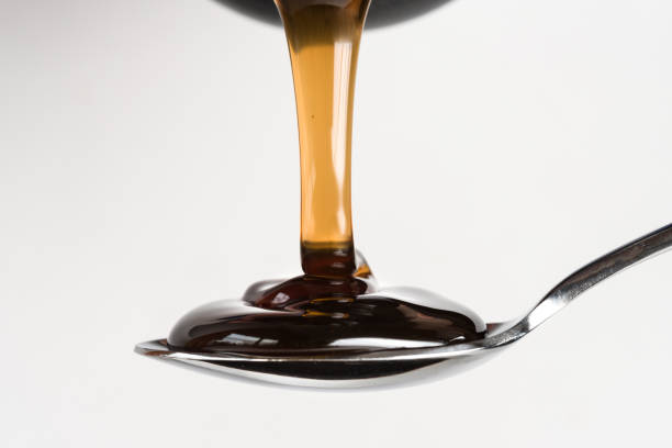 Pouring Dark Corn Syrup on a Spoon stock photo