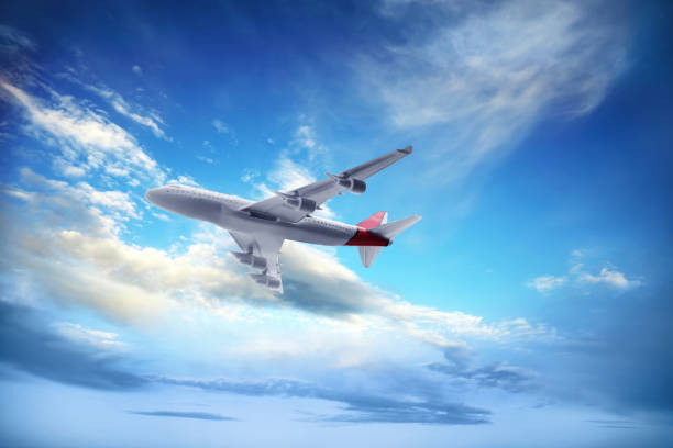 istock Airplane flying in blue sky with clouds. Air transportation 1384268293