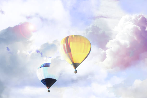 istock Fantastic dreams. Hot air balloons in sky with fluffy clouds 1384268301