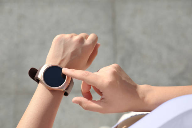 istock Woman checking fitness tracker after training outdoors, closeup 1384268487