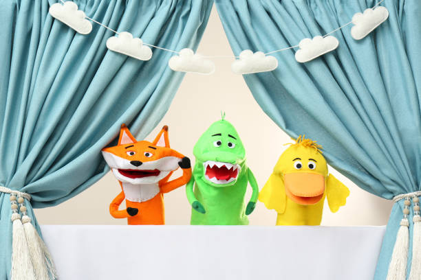 Creative puppet show on white stage indoors Creative puppet show on white stage indoors puppet stock pictures, royalty-free photos & images